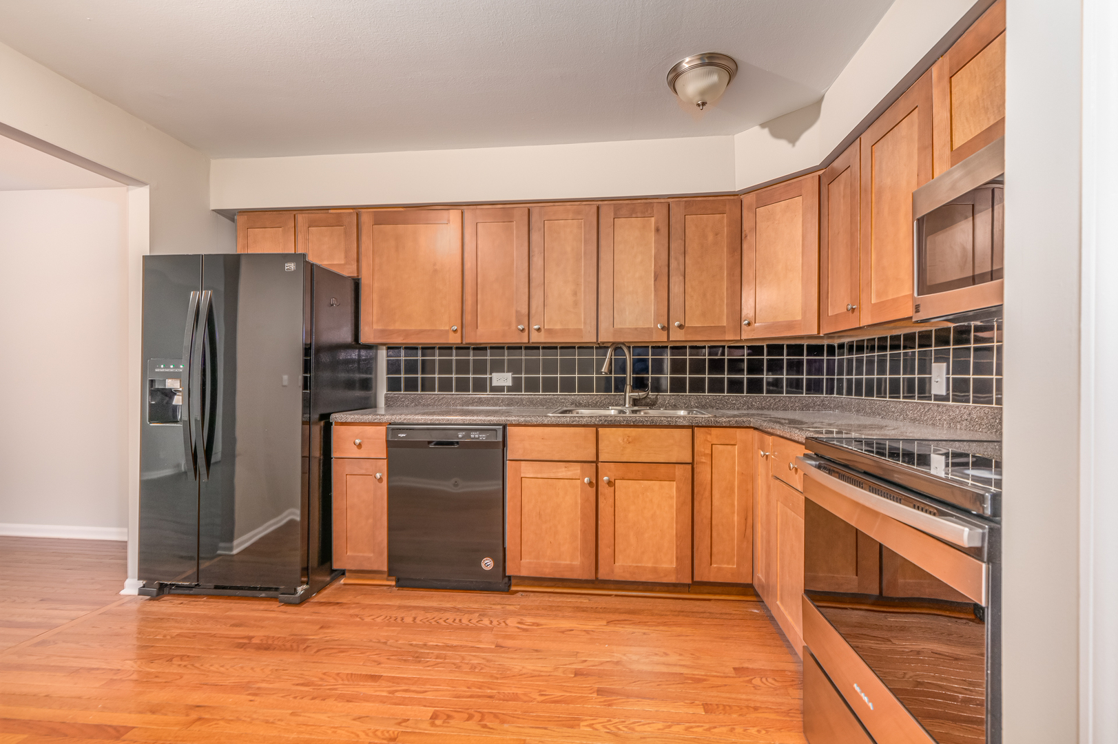 850 South Lorraine Road, Unit 1J Wheaton, IL 60189 - Photo 10 of 22 a kitchen with stainless steel appliances granite countertop a refrigerator and a sink