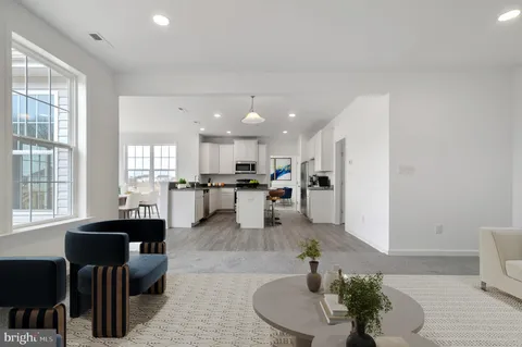 a living room with furniture and kitchen view