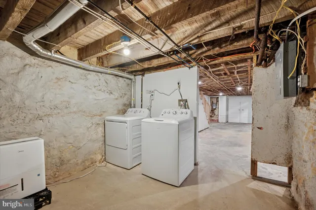 a utility room with a wooden floor washer and dryer
