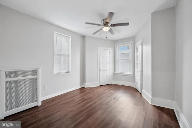 a view of a room with wooden floor closet and windows