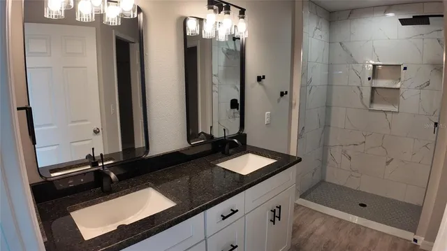 a bathroom with a double vanity sink and a mirror
