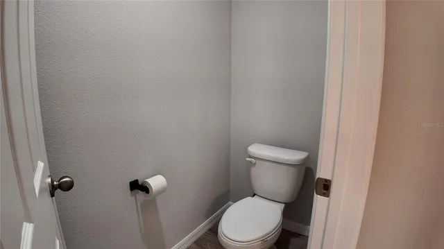 a white toilet sitting next to a shower