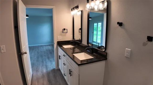 a bathroom with a sink a toilet a mirror and vanity