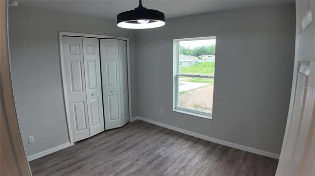 a view of a room with wooden floor and a sink
