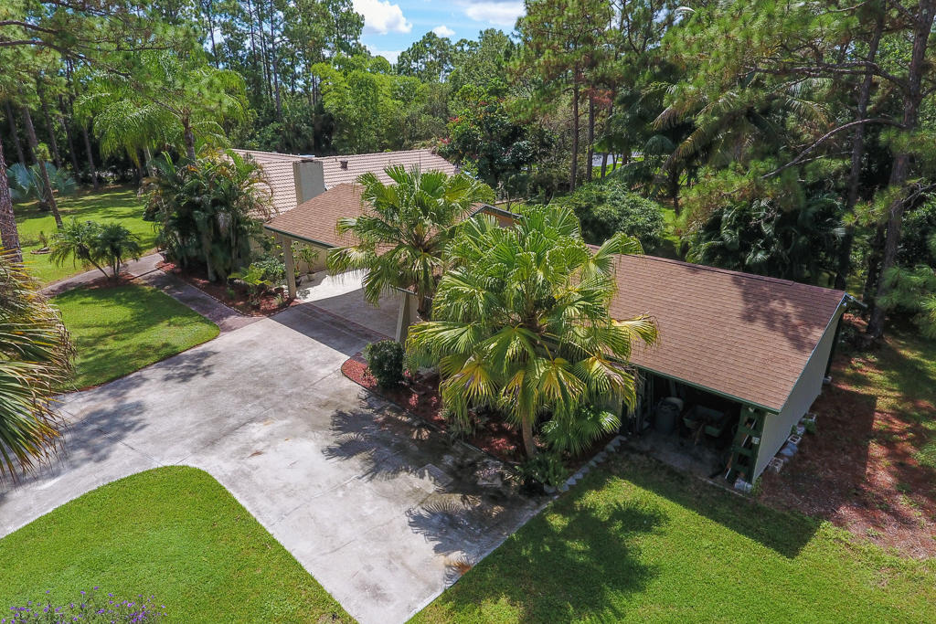 15429 Jupiter Farms Road Jupiter, FL 33478 - Photo 50 of 59 a view of a backyard with plants and a patio