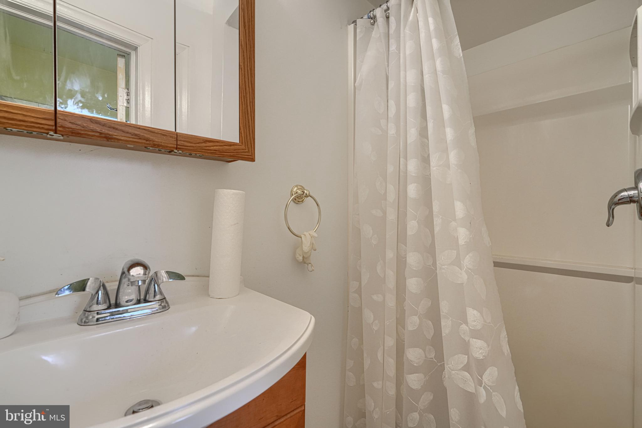3212 Dorchester Road Baltimore, MD 21215 - Photo 19 of 45 a bathroom with a sink and a mirror