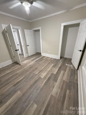 a view of a room with wooden floor and staircase
