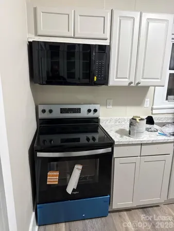 a close view of a stove a microwave and cabinets