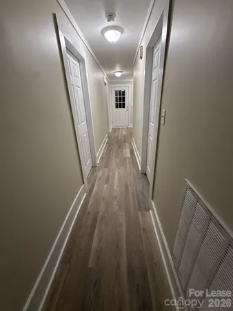 a view of a hallway and wooden floor