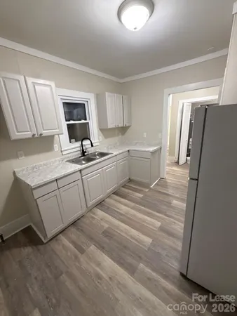 a kitchen with a sink cabinets and appliances