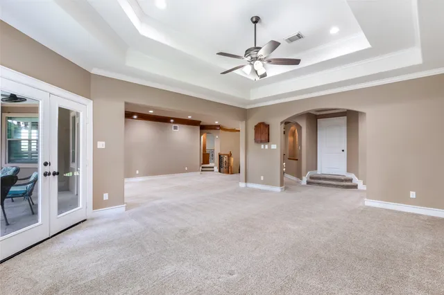 a view of a livingroom with a ceiling fan and window
