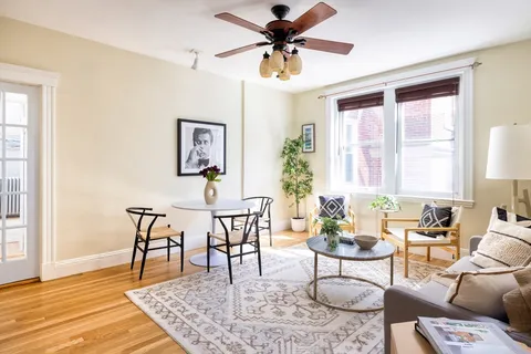 a view of a livingroom and dining room with wooden floor