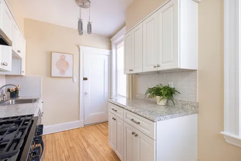 a kitchen with stainless steel appliances granite countertop a refrigerator and a stove top oven