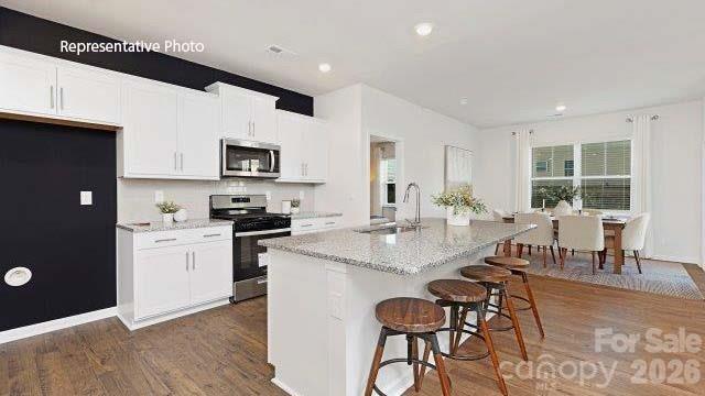1024 Horizon Lane Chester, SC 29706 - Photo 5 of 21 a kitchen with stainless steel appliances granite countertop a stove a sink dishwasher and a refrigerator with wooden floor