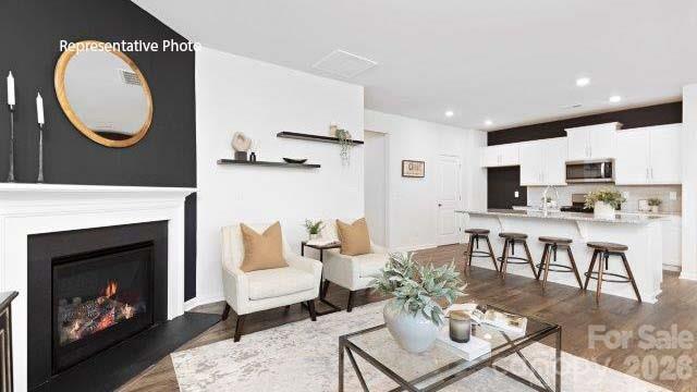 1024 Horizon Lane Chester, SC 29706 - Photo 9 of 21 a living room with furniture a fireplace and kitchen view