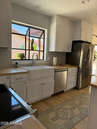 a kitchen with a refrigerator sink and cabinets