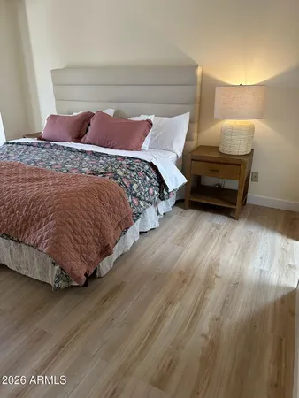 a bed sitting in a bedroom next to a lamp