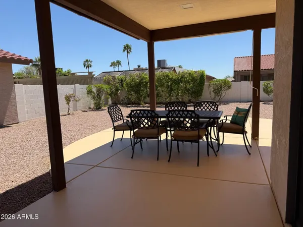 a view of a chairs and table in the balcony