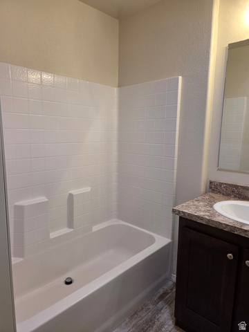 1275 Thrush Road Salt Lake City, UT 84123 - Photo 14 of 20 Full bathtub with white tiled surround in the master bedroom
