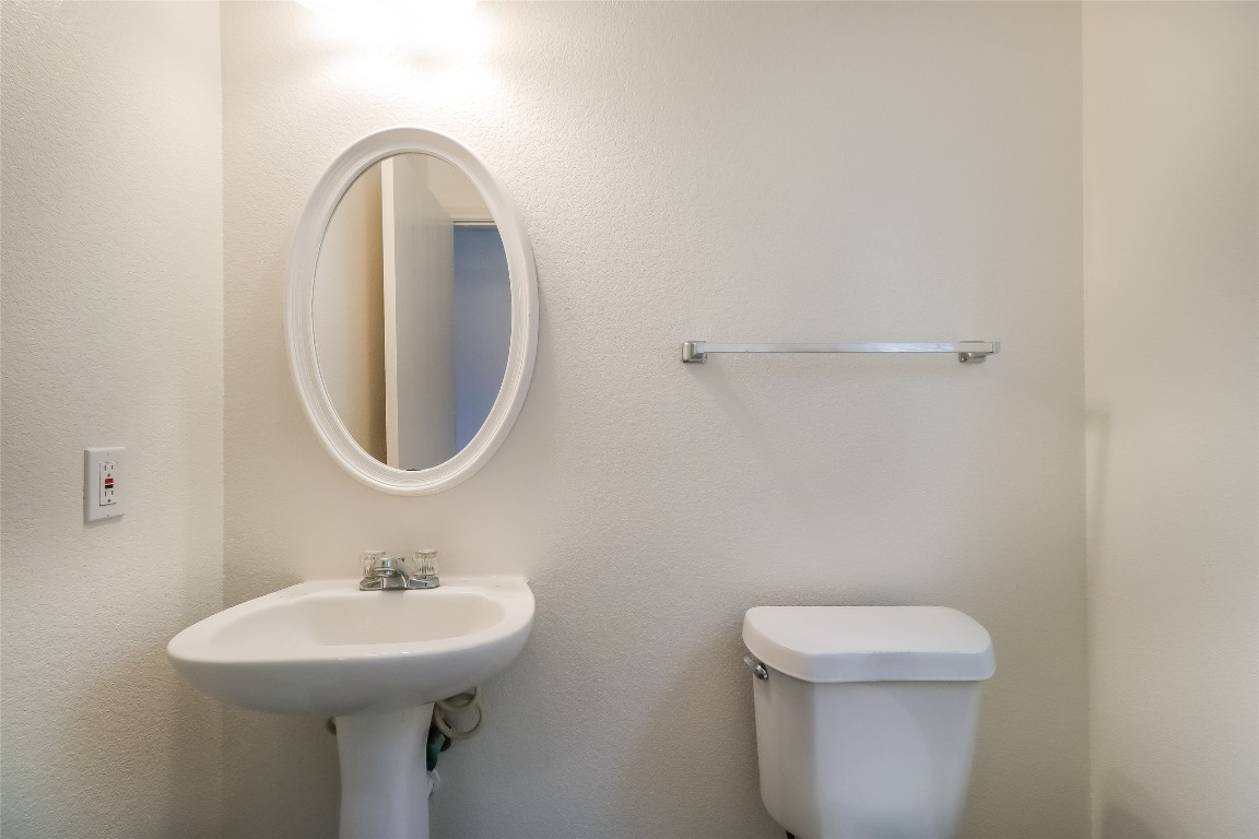 7012 Doyal Drive Austin, TX 78747 - Photo 16 of 17 a bathroom with a sink a toilet and a mirror
