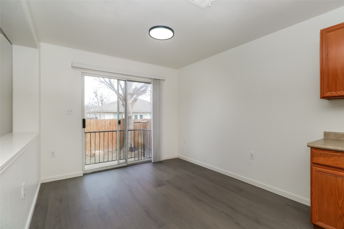 7012 Doyal Drive Austin, TX 78747 - Photo 6 of 17 an empty room with wooden floor and windows