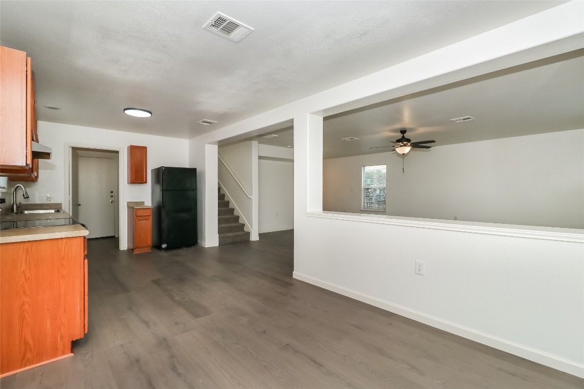 7012 Doyal Drive Austin, TX 78747 - Photo 7 of 17 a view of a kitchen with refrigerator and windows