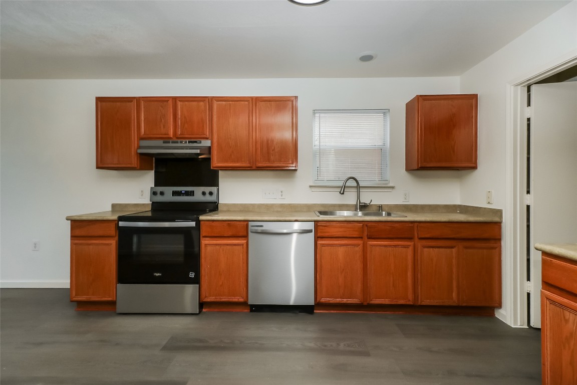 7012 Doyal Drive Austin, TX 78747 - Photo 8 of 17 a kitchen with stainless steel appliances granite countertop a stove and a sink