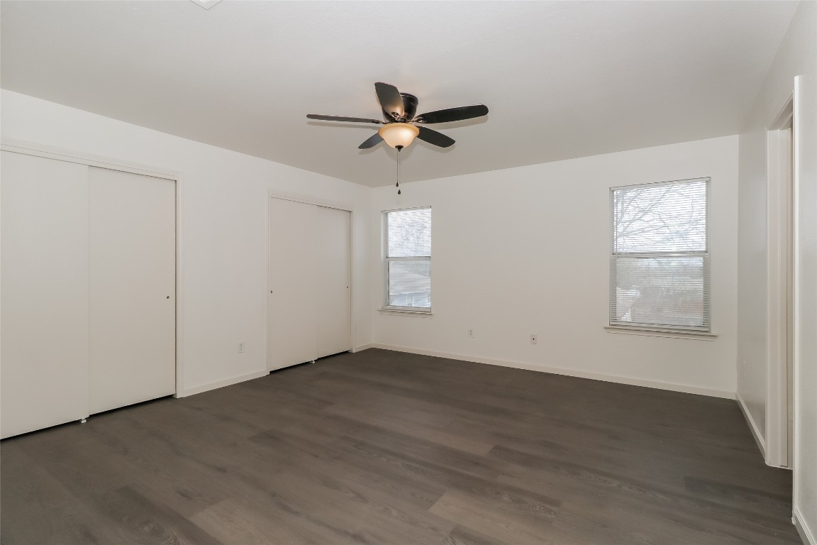 7012 Doyal Drive Austin, TX 78747 - Photo 10 of 17 an empty room with wooden floor ceiling fan and windows