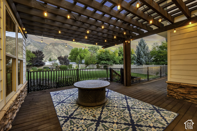 259 Twin River Loop Alpine, UT 84004 - Photo 53 of 61 Expansive outdoor deck featuring a wooden pergola, string lighting, and mountain scenery