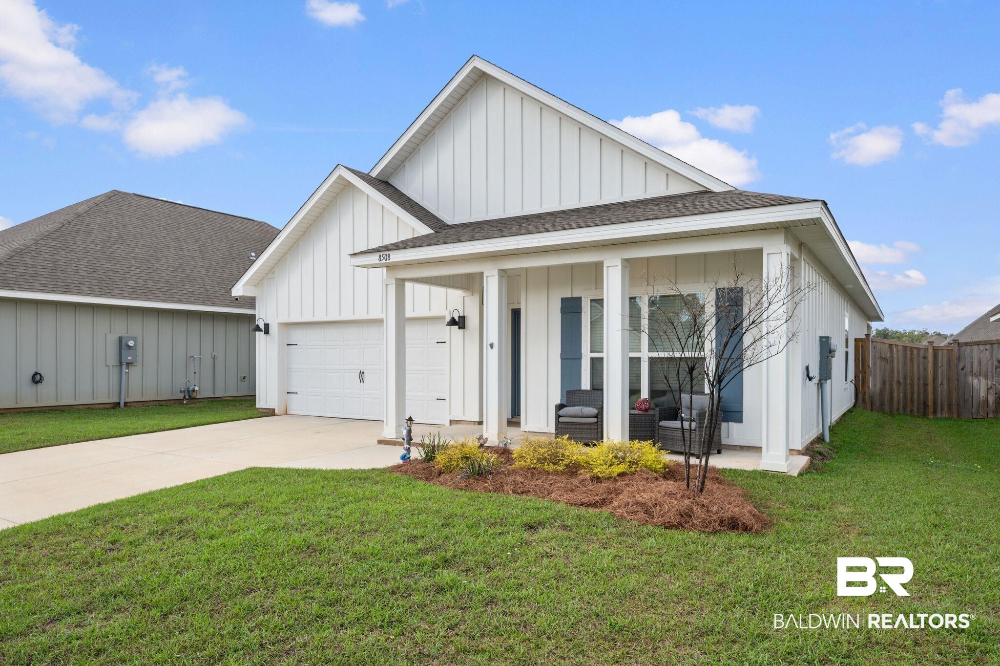 8508 Rosedown Lane Daphne, AL 36526 - Photo 1 of 29 Modern inspired farmhouse with board and batten siding, roof with shingles, driveway, a garage, and a porch