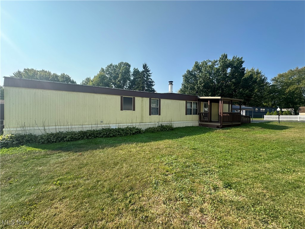 5852 Cleveland Road, Unit 21 Wooster, OH 44691 - Photo 2 of 17 Rear view of house featuring a lawn