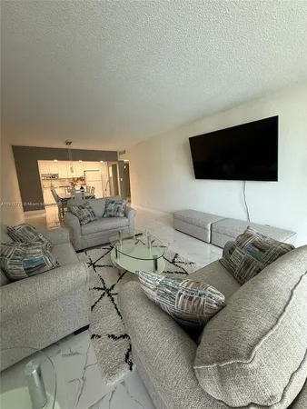 a living room with couches and a flat screen tv