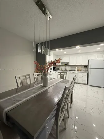 an open kitchen with a table and chairs