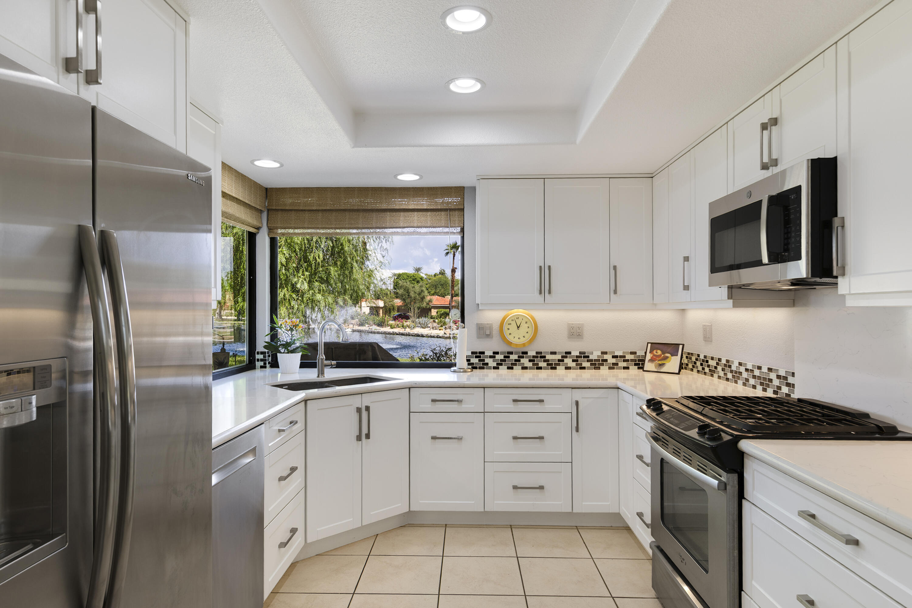5 Valencia Drive Rancho Mirage, CA 92270 - Photo 12 of 45 a kitchen with granite countertop a sink stainless steel appliances and cabinets