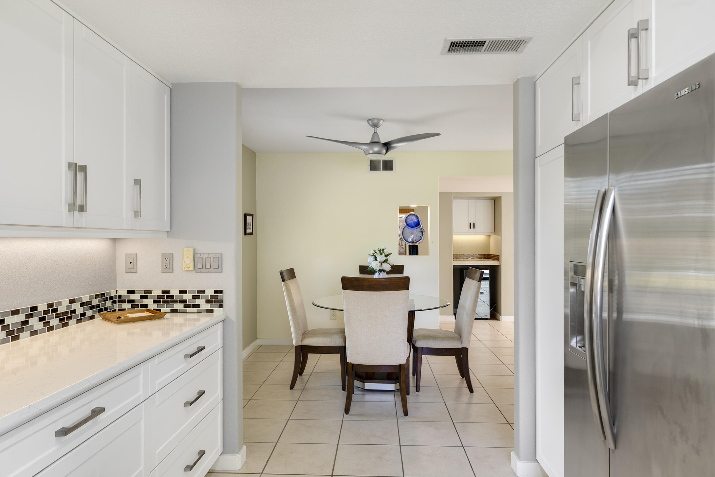 5 Valencia Drive Rancho Mirage, CA 92270 - Photo 14 of 45 a kitchen with a table chairs refrigerator and cabinets