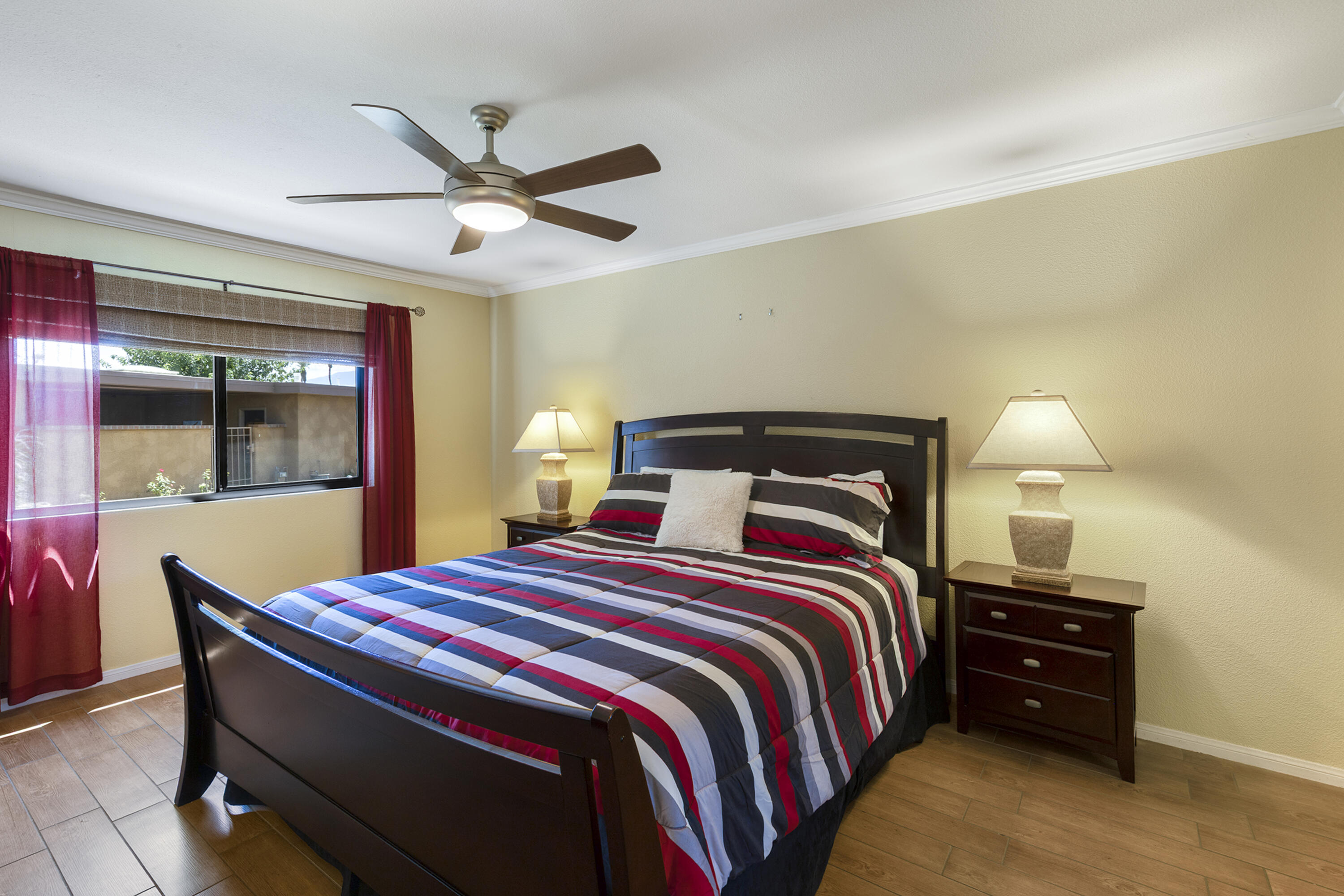 5 Valencia Drive Rancho Mirage, CA 92270 - Photo 15 of 45 a bedroom with a bed and wooden floor