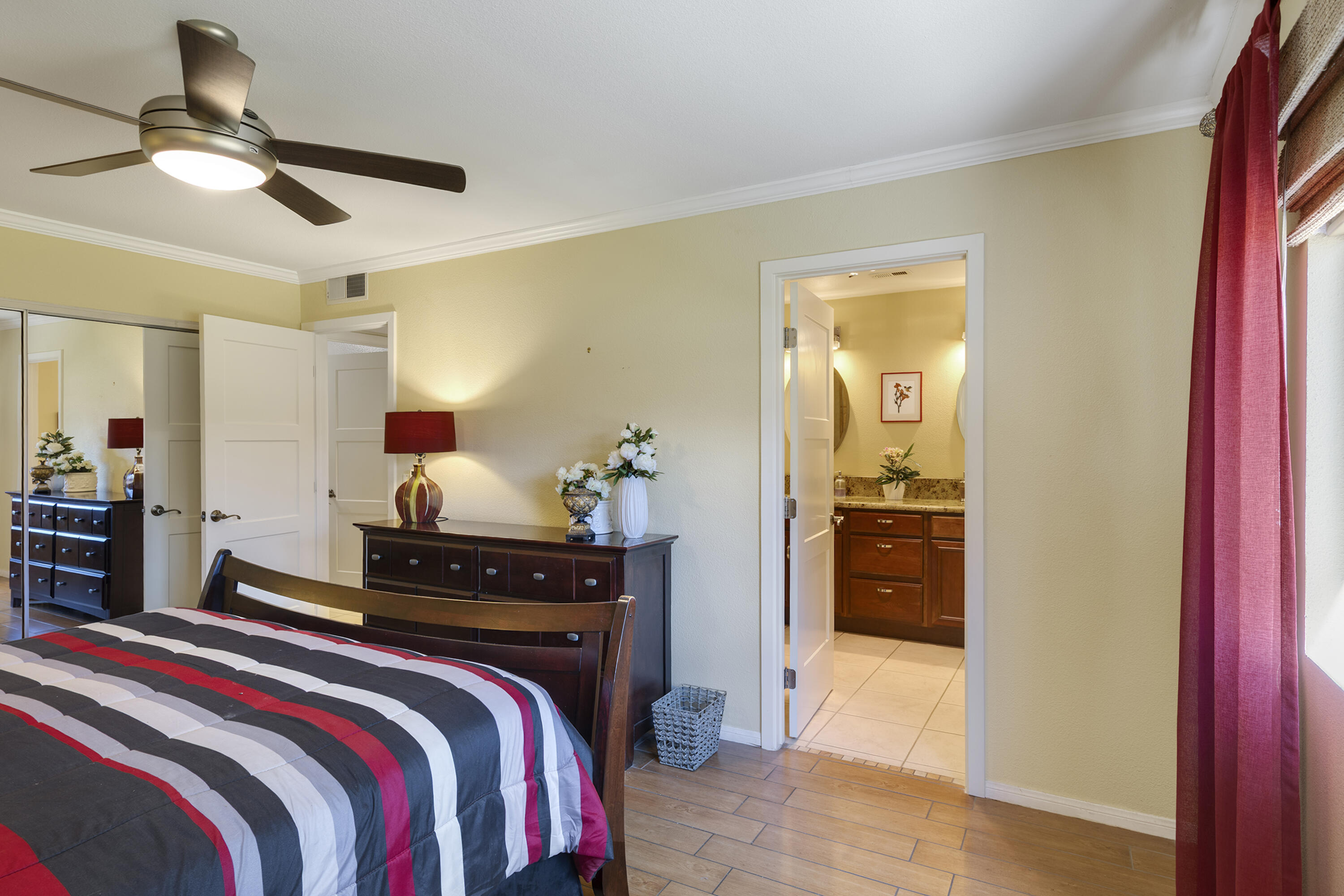 5 Valencia Drive Rancho Mirage, CA 92270 - Photo 18 of 45 a bedroom with a bed and a chandelier