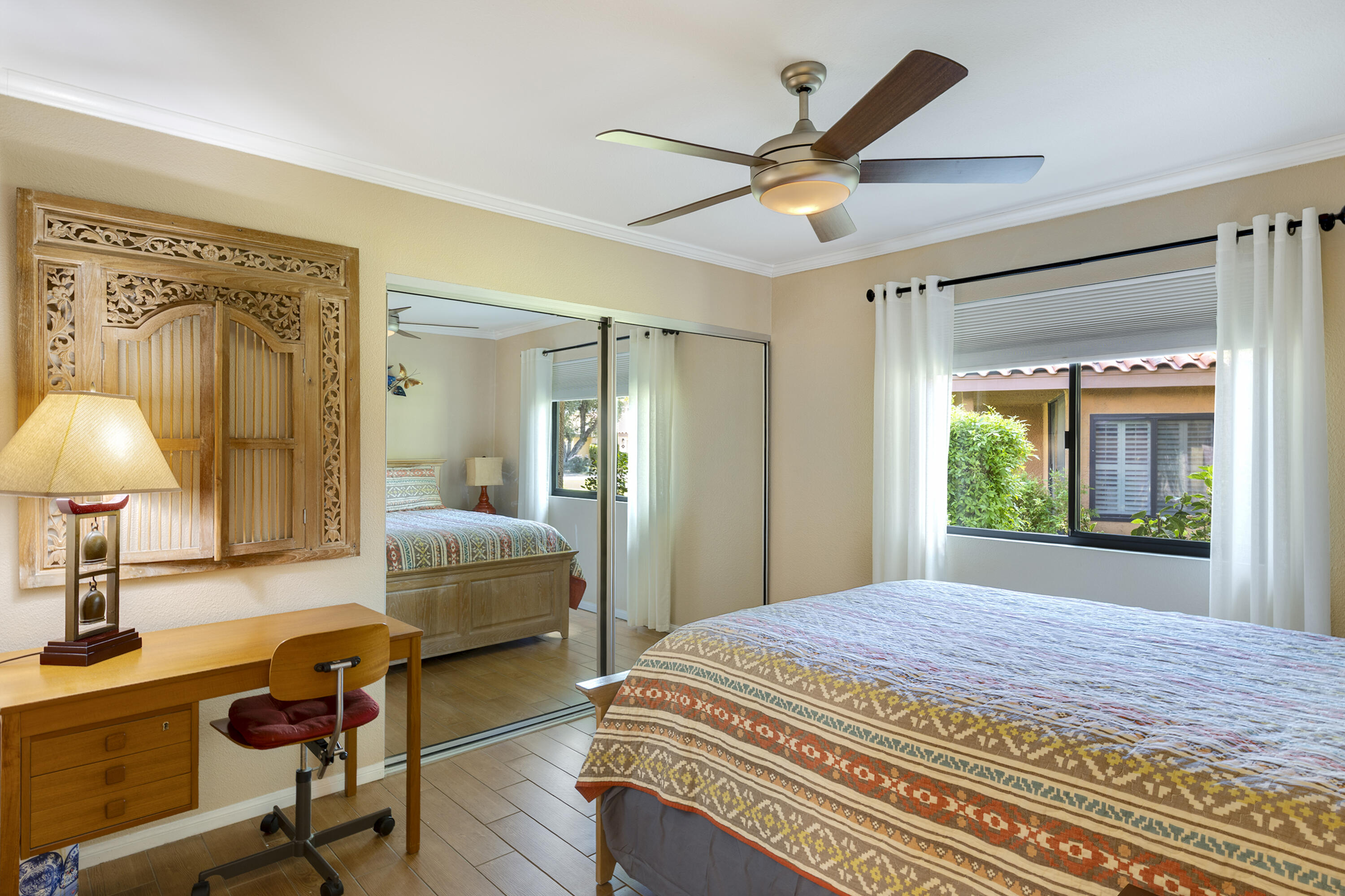 5 Valencia Drive Rancho Mirage, CA 92270 - Photo 21 of 45 a bedroom with a bed and a chandelier