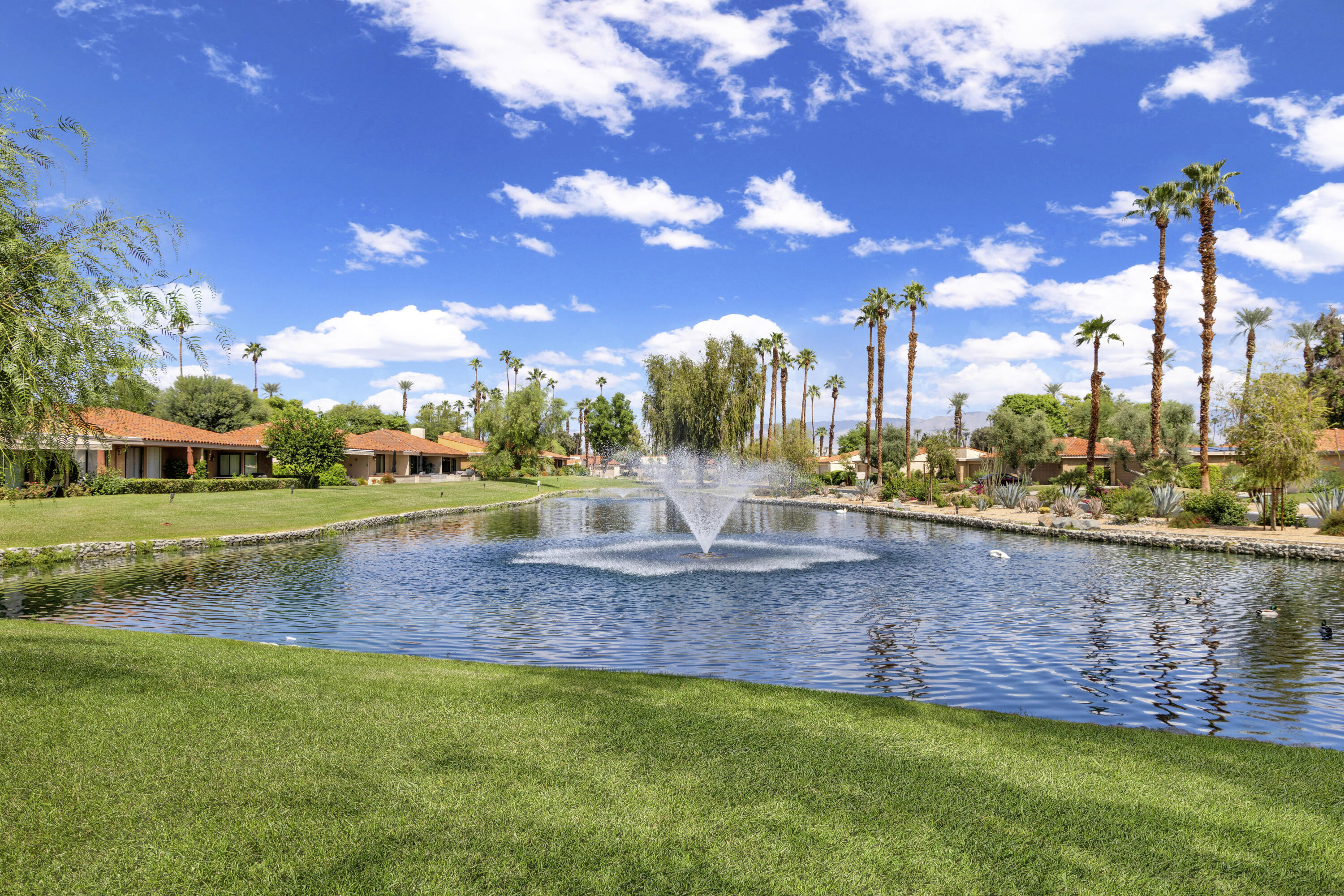 5 Valencia Drive Rancho Mirage, CA 92270 - Photo 30 of 45 a view of a fountain in a yard with palm trees