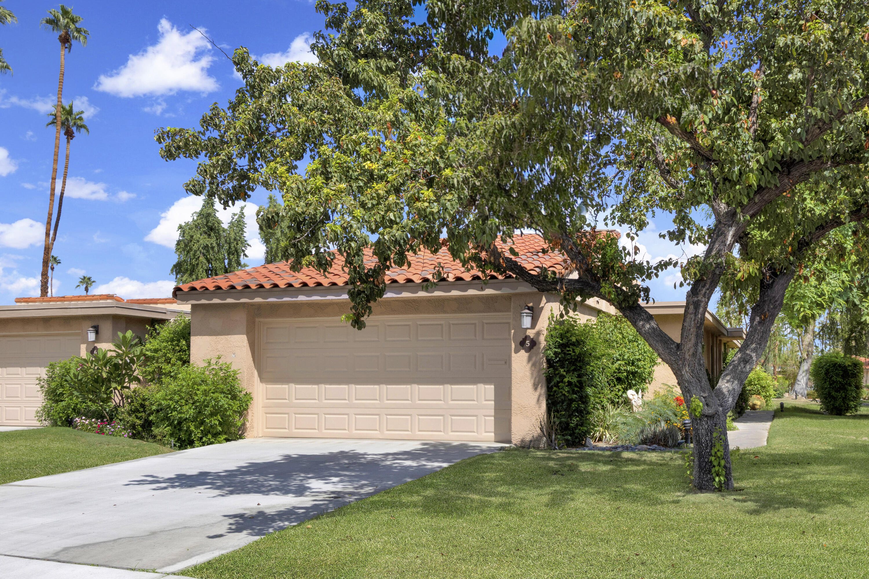 5 Valencia Drive Rancho Mirage, CA 92270 - Photo 3 of 45 a view of a house with a tree and a yard
