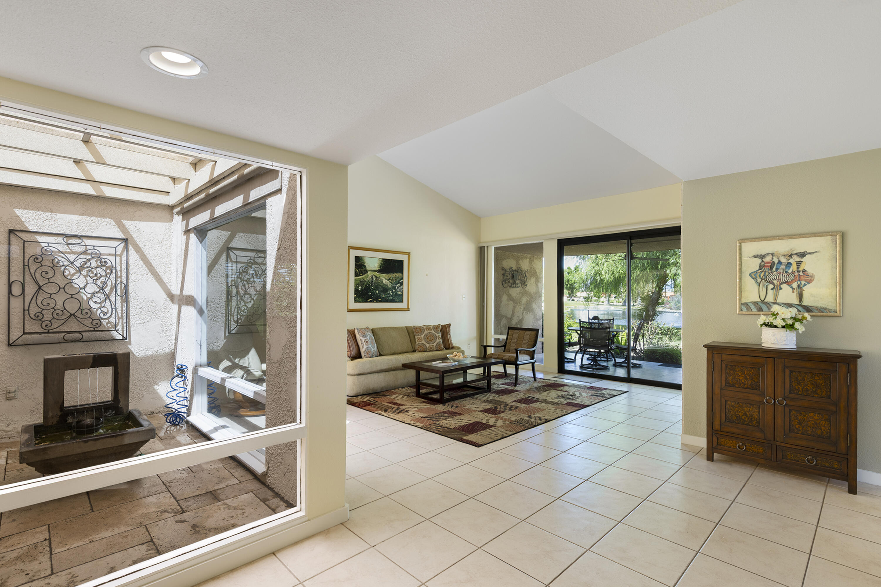 5 Valencia Drive Rancho Mirage, CA 92270 - Photo 7 of 45 a living room with furniture a fireplace and a window