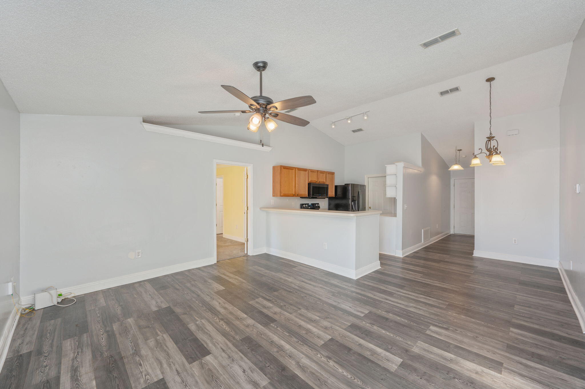 a view of a kitchen with wooden floor and window