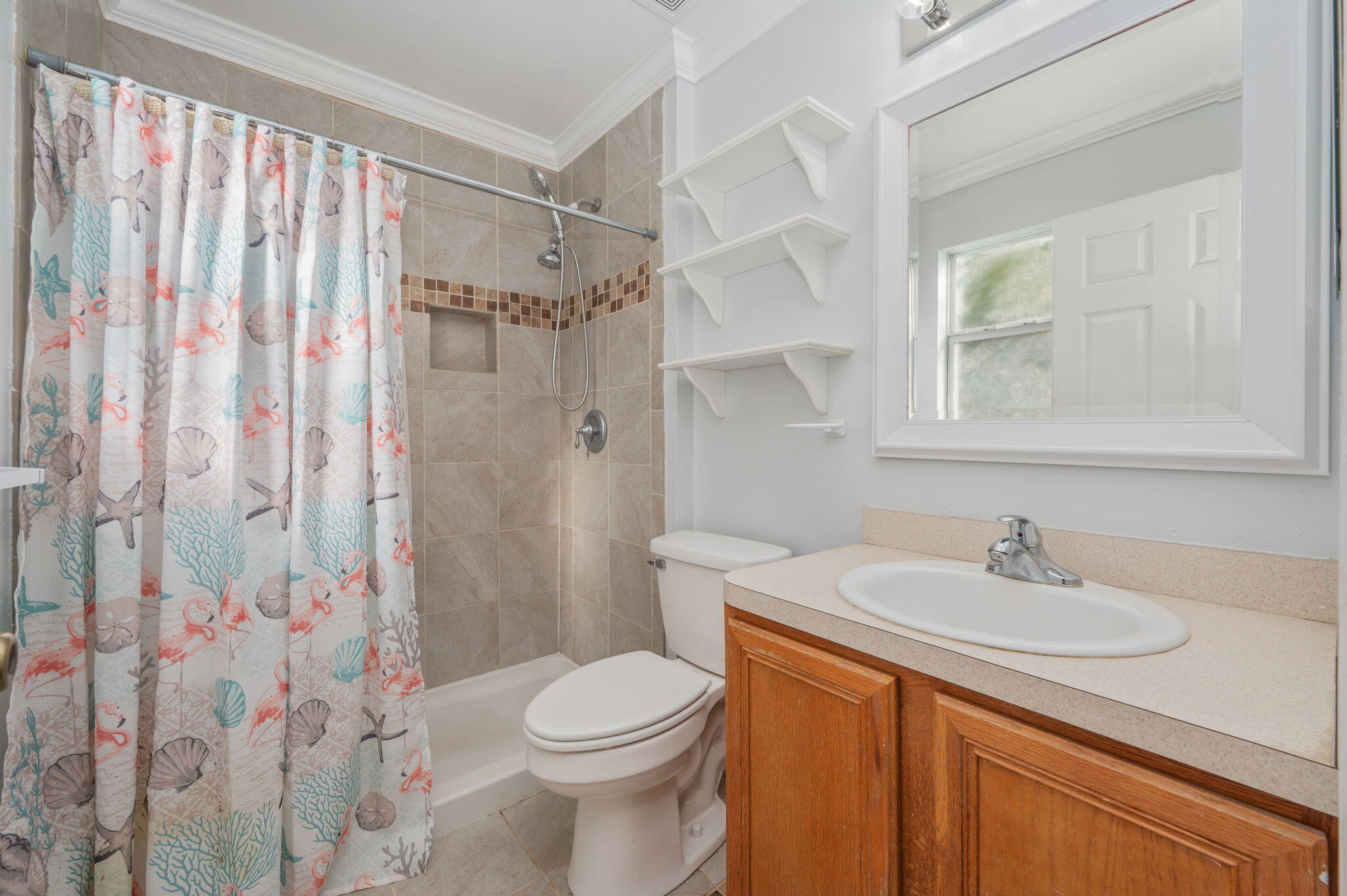 410 Winddrift Court Crestview, FL 32536 - Photo 20 of 44 a bathroom with a sink a toilet and shower curtain