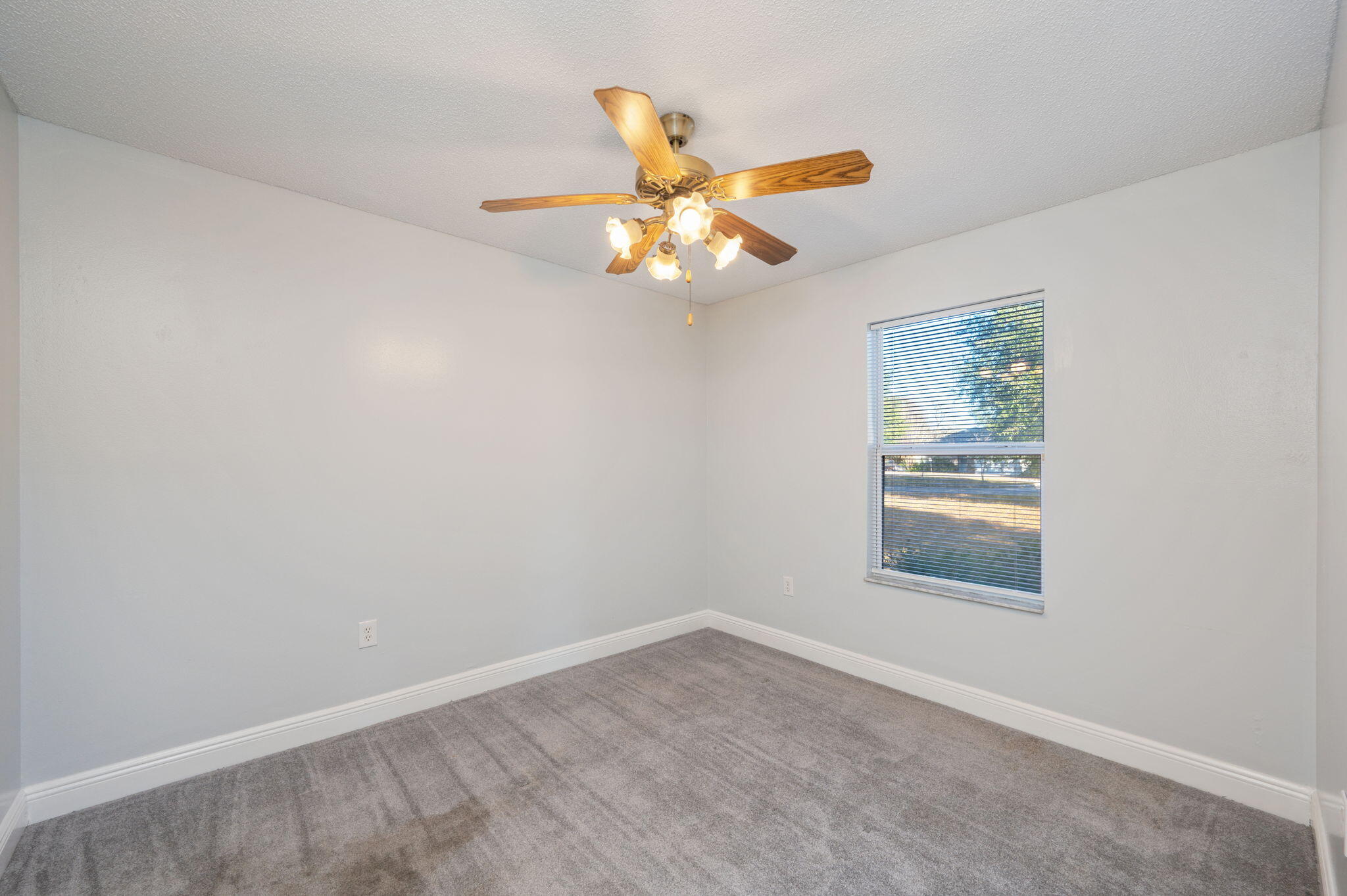 410 Winddrift Court Crestview, FL 32536 - Photo 26 of 44 an empty room with windows and fan