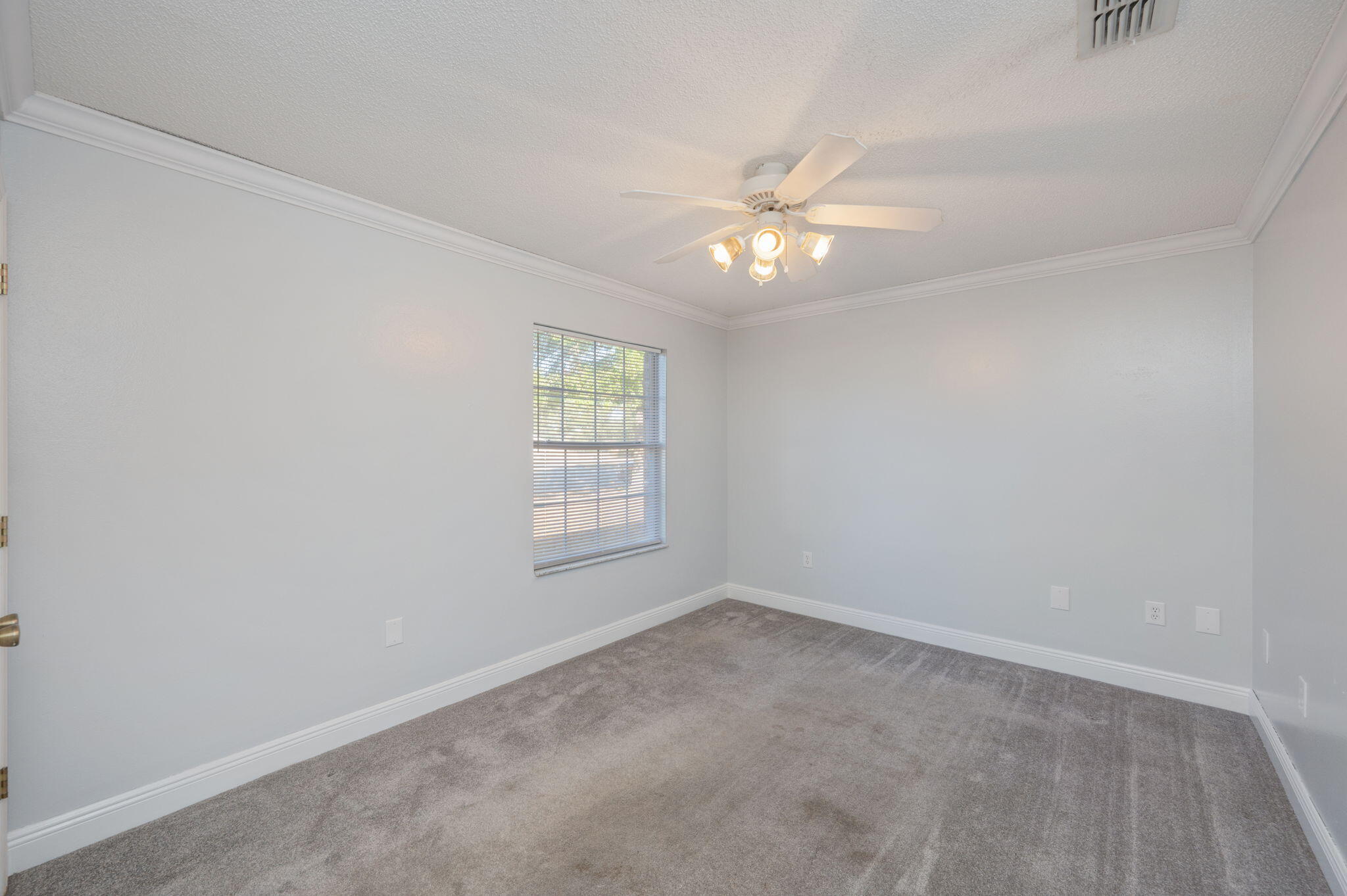 410 Winddrift Court Crestview, FL 32536 - Photo 31 of 44 an empty room with a window and ceiling fan