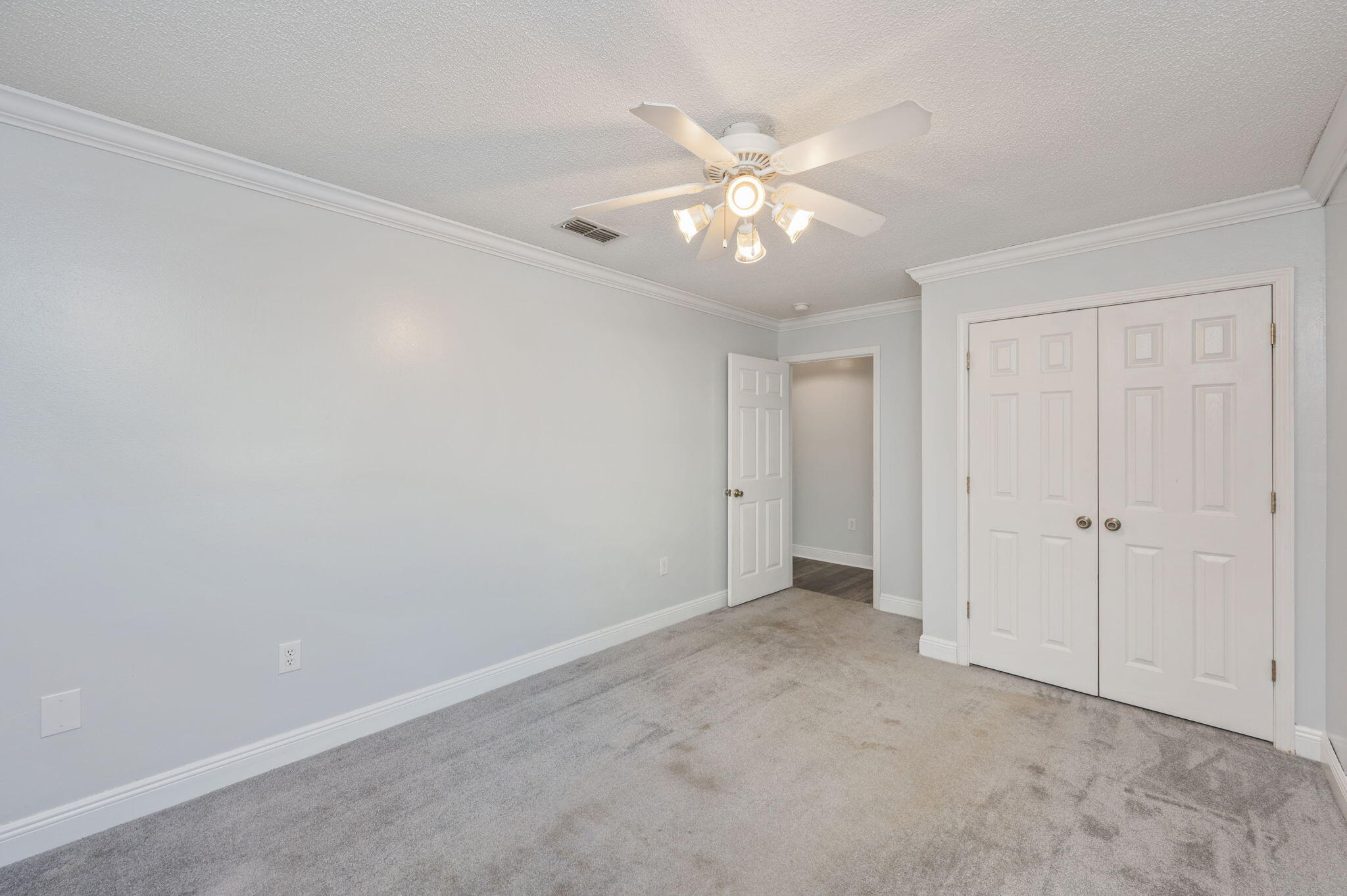 410 Winddrift Court Crestview, FL 32536 - Photo 32 of 44 a view of an empty room with a chandelier fan
