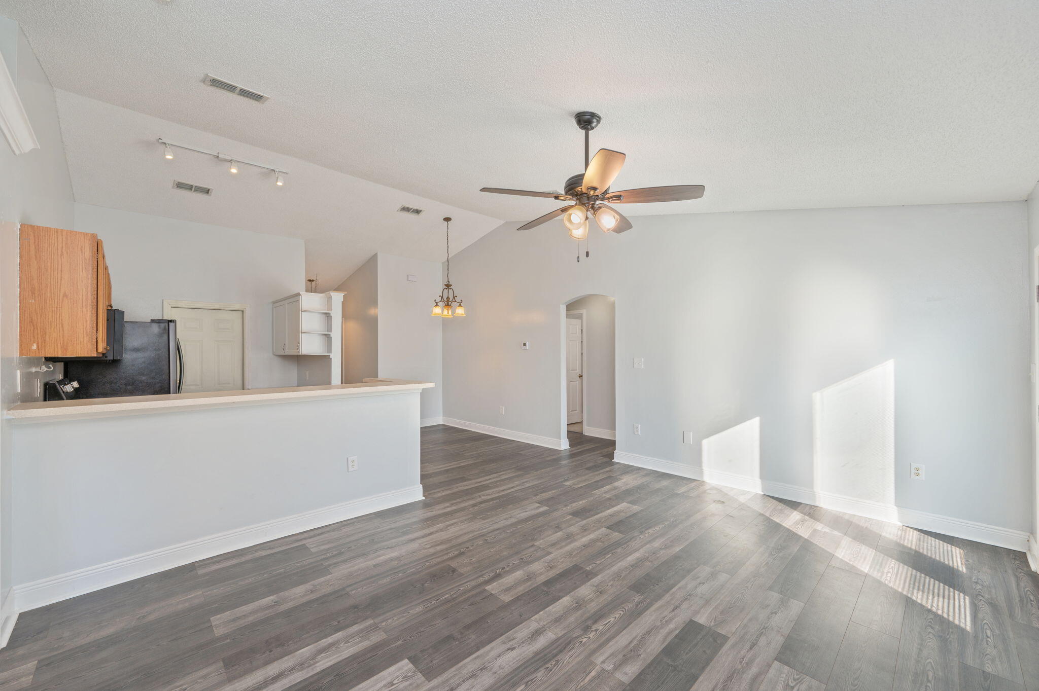 410 Winddrift Court Crestview, FL 32536 - Photo 8 of 44 a view of a room with wooden floor and ceiling fan