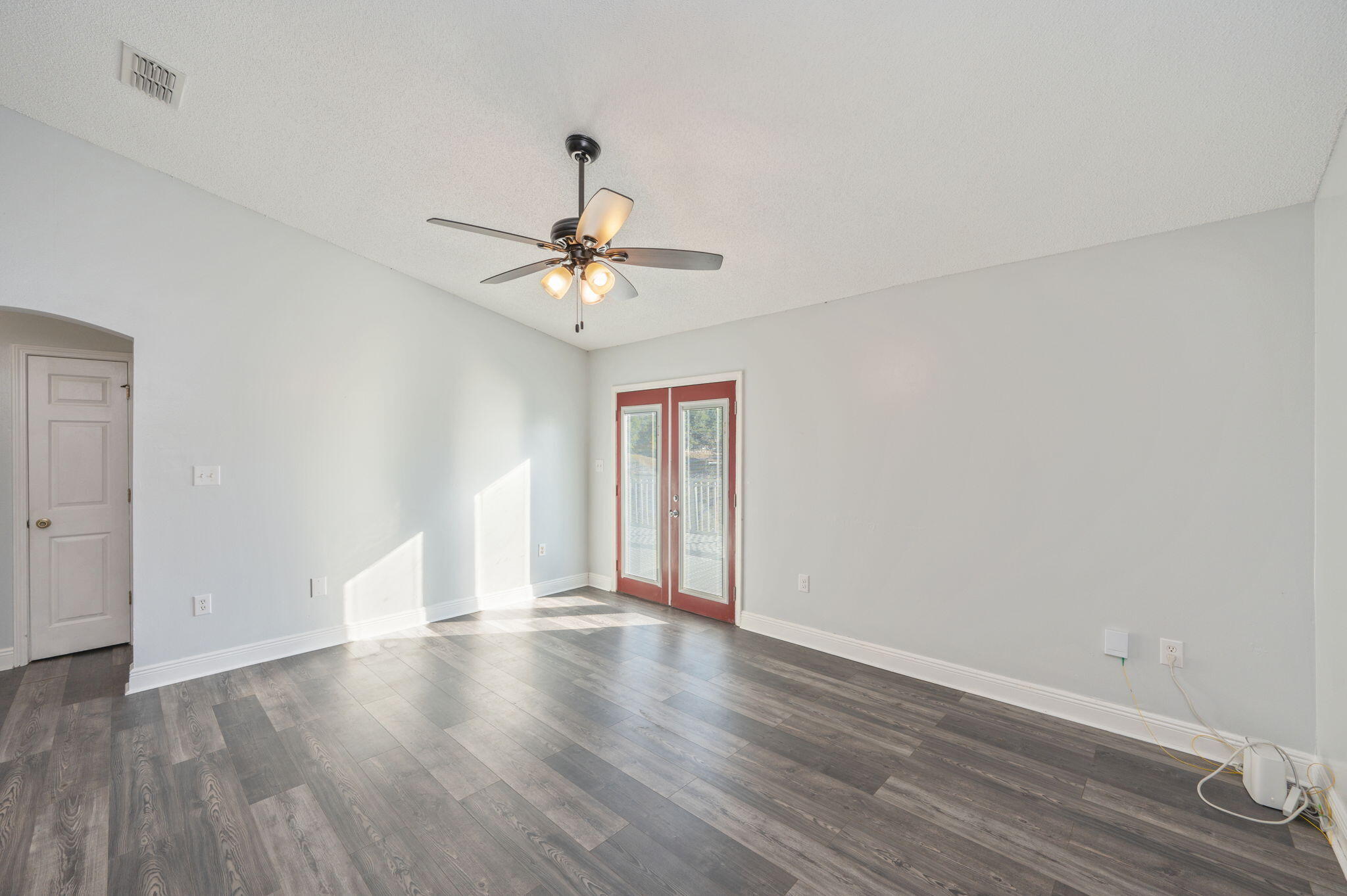410 Winddrift Court Crestview, FL 32536 - Photo 9 of 44 a view of an empty room with wooden floor