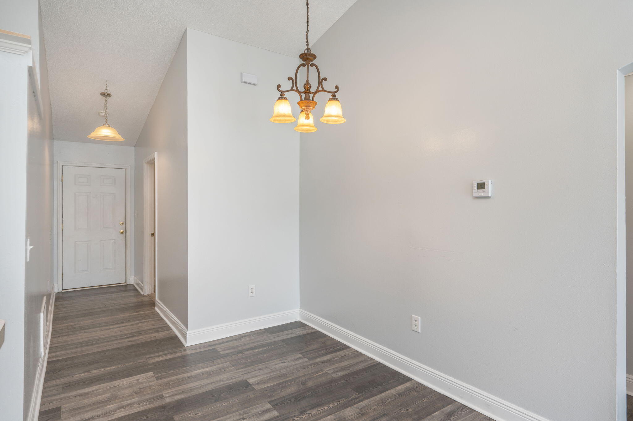 410 Winddrift Court Crestview, FL 32536 - Photo 10 of 44 a view of a chandelier in big room with wooden floor