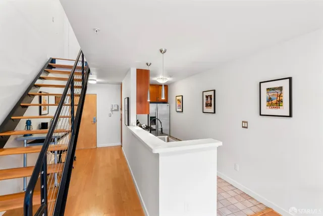 a view of a kitchen with furniture and staircase
